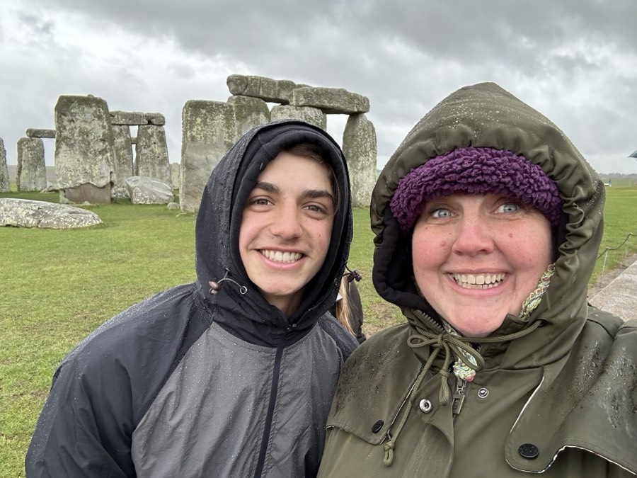 A GoXL trip leader and student at Stonehenge in the rain
