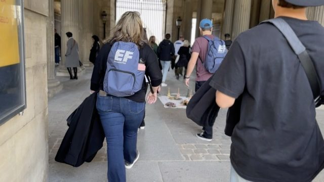 GoXL students walking into the Louvre with EF backpacks